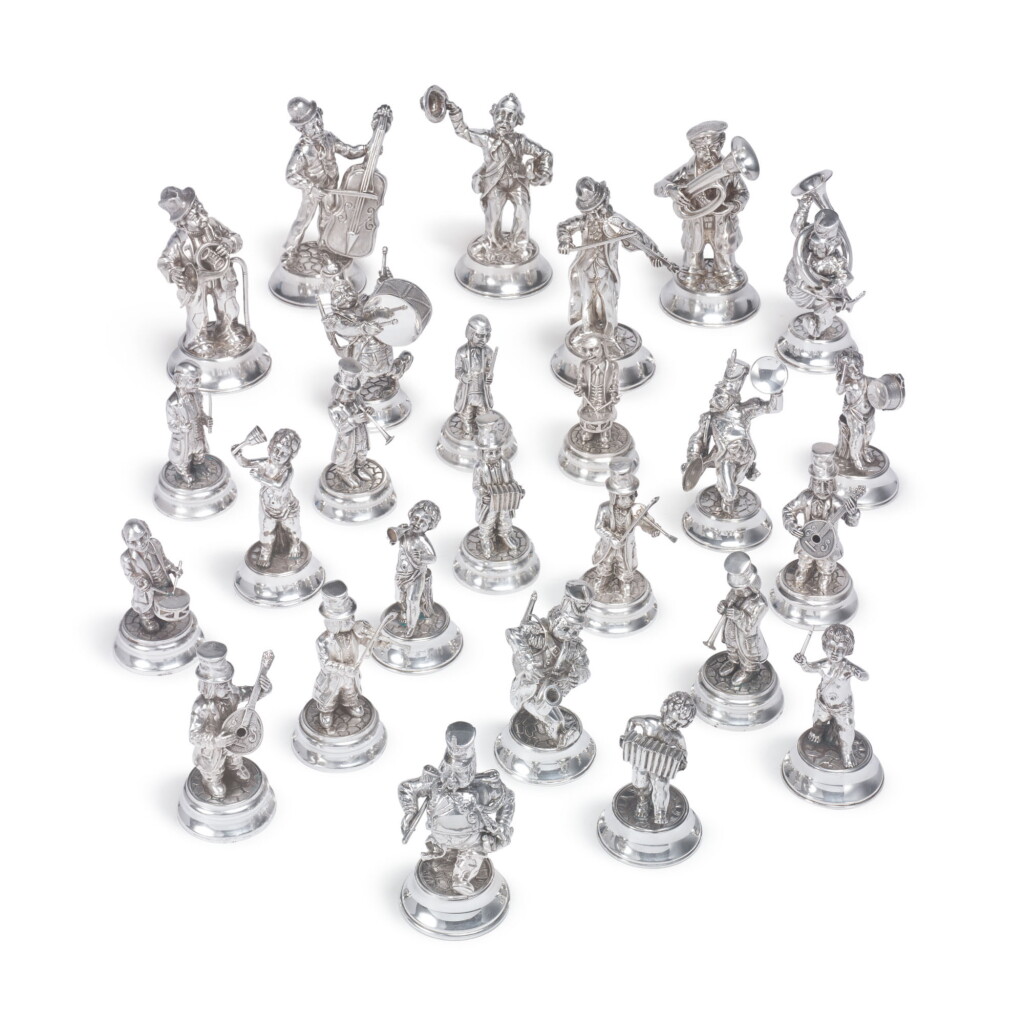 View full screen - View 1 of Lot 883. A GROUP OF TWENTY-SIX SPANISH SILVER MUSICIAN FIGURES, MID 20TH CENTURY.