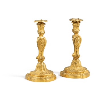 View full screen - View 1 of Lot 67. A pair of Louis XV gilt-bronze candlesticks, in the manner of Jules-Aurèle Meissonnier (1675-1750), circa 1730 | Paire de flambeaux en bronze ciselé et doré d'époque Louis XV, dans le style de Jules-Aurèle Meissonnier (1675-1750), circa 1730.
