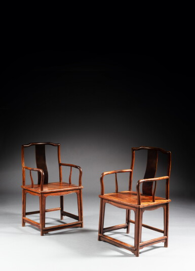 View full screen - View 1 of Lot 182. A pair of huanghuali continuous yokeback armchairs (Nanguanmaoyi), Ming dynasty, 16th century | 明十六世紀 黃花梨南官帽椅一對.