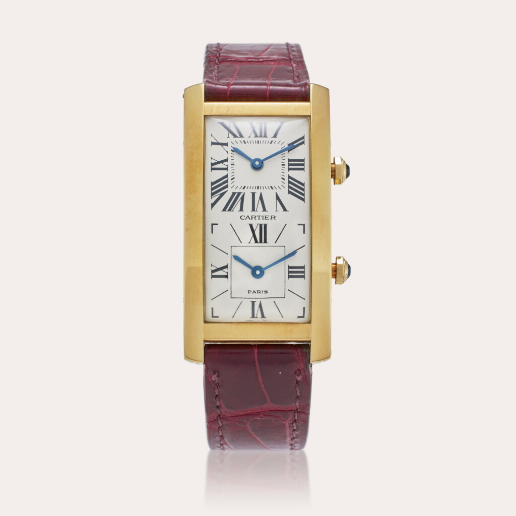 View full screen - View 1 of Lot 77. Tank Cintrée Dual Time | A yellow gold dual time zone rectangular wristwatch, Circa 1990.