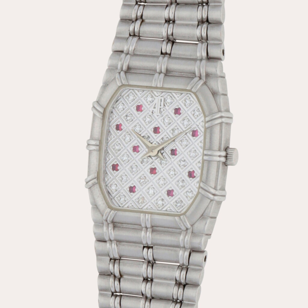 View full screen - View 1 of Lot 275. Bamboo | A white gold wristwatch with integrated bracelet, ruby indexes and diamond-set dial | Circa 1985.