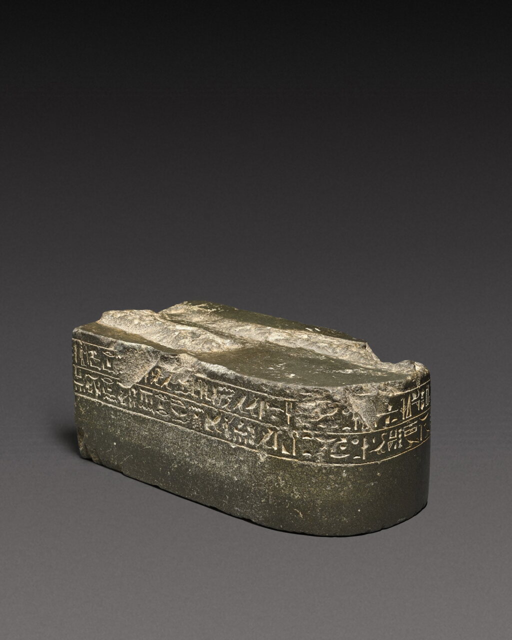 View full screen - View 1 of Lot 140. An Egyptian Greywacke Inscribed Statue Base, Late Period, 712-30 B.C.