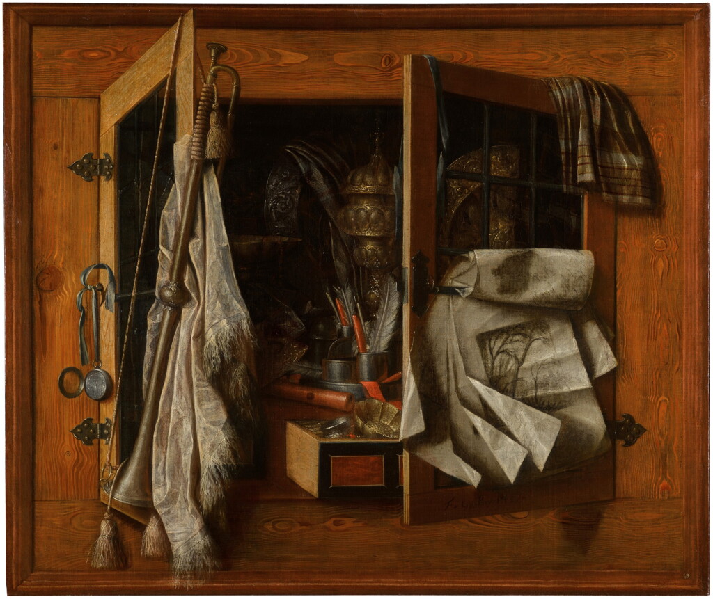 View full screen - View 1 of Lot 155. A trompe-l’œil still life of a half-open cupboard with gilded vessels, writing implements, a recorder, gold coins, a trumpet and drawings, in a painted frame.