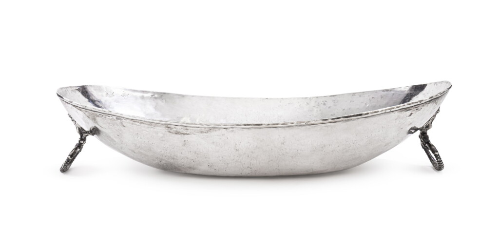 View full screen - View 1 of Lot 301. A large silver oval two-handled basin, unmarked, probably Argentina, late 19th century/early 20th century | Grand bassin ovale à deux anses en argent, non poinçonné, probablement Argentine, fin XIXe siècle/début XXe siècle.