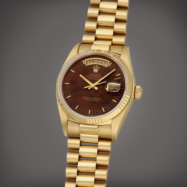 View full screen - View 1 of Lot 1. Day-Date, Reference 18038 | A yellow gold wristwatch with day, date, burl wood dial and bracelet | Circa 1979.