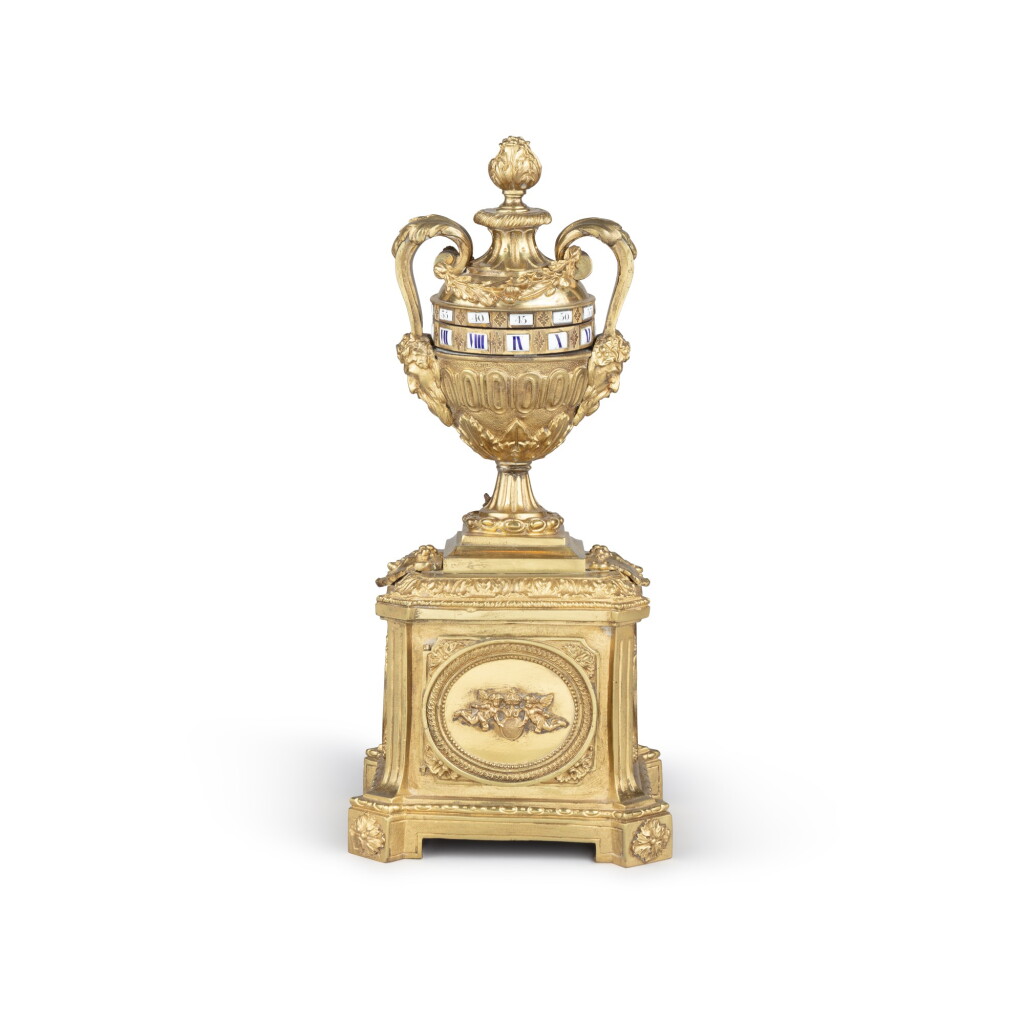 View full screen - View 1 of Lot 60. A Louis XVI style gilt-bronze cercles tournants urn clock | Pendule urne à cercles tournants en bronze doré de style Louis XVI.