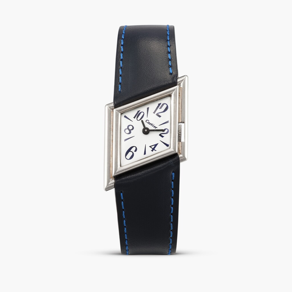 View full screen - View 1 of Lot 2409. Tank Asymétrique/ Parallélogramme | A rare white gold asymmetrical wristwatch with blue numerals and original white and pink gold deployant buckle, Circa 1992.