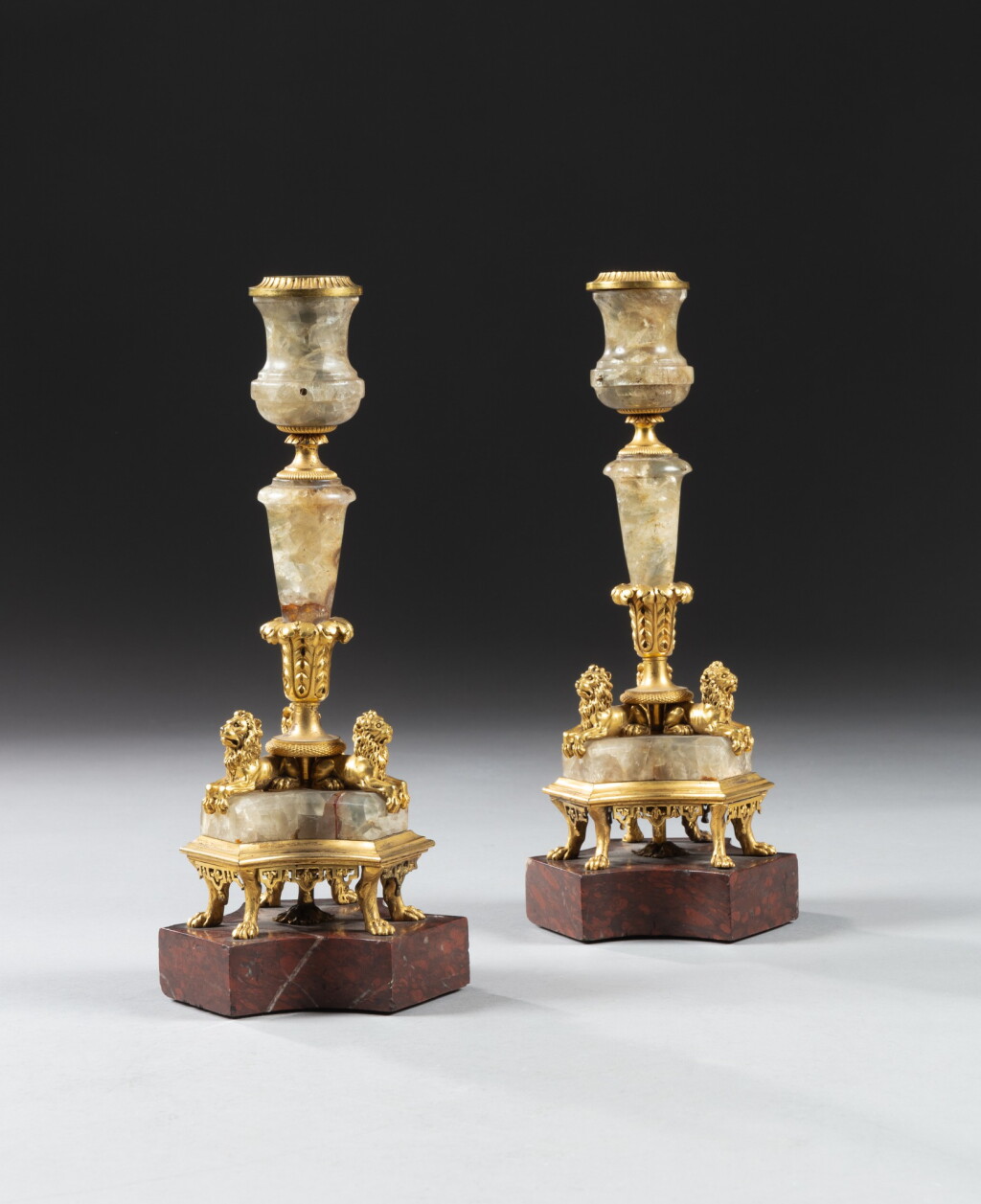 View full screen - View 1 of Lot 24. A pair of gilt-bronze mounted onyx candlesticks, probably continental, late 18th century | Paire de flambeaux en onyx et bronze doré, travail probablement étranger de la fin du XVIIIe siècle.