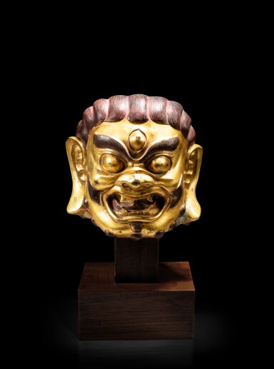 View full screen - View 1 of Lot 36. A gilt-copper alloy head of a tantric figure, Tibet or Mongolia, circa 18th century | 西藏或蒙古 約十八世紀 鎏金銅合金首像.
