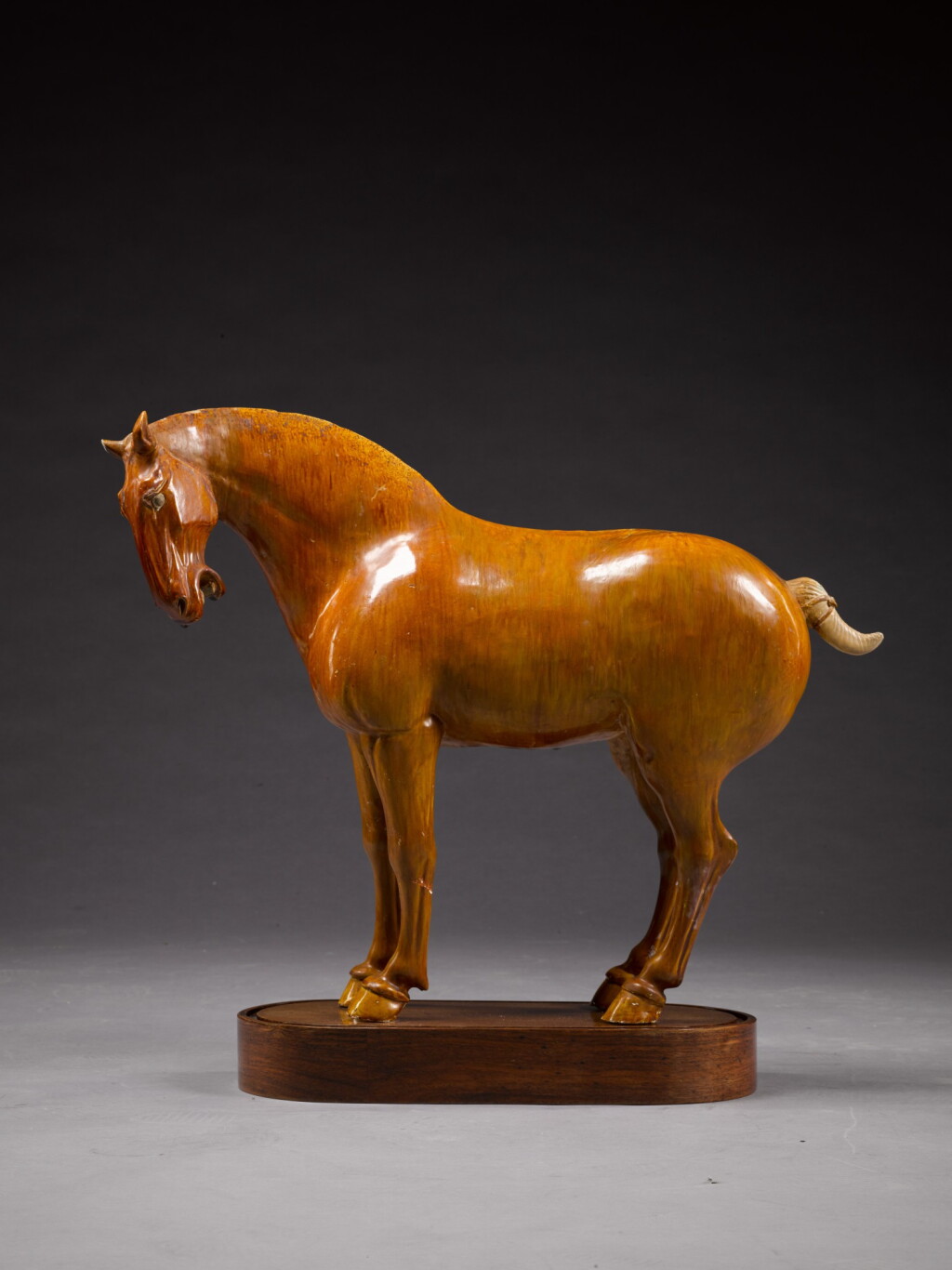 View full screen - View 1 of Lot 103. A large amber-glazed pottery model of a horse, Tang Dynasty | 唐 黃釉馬.