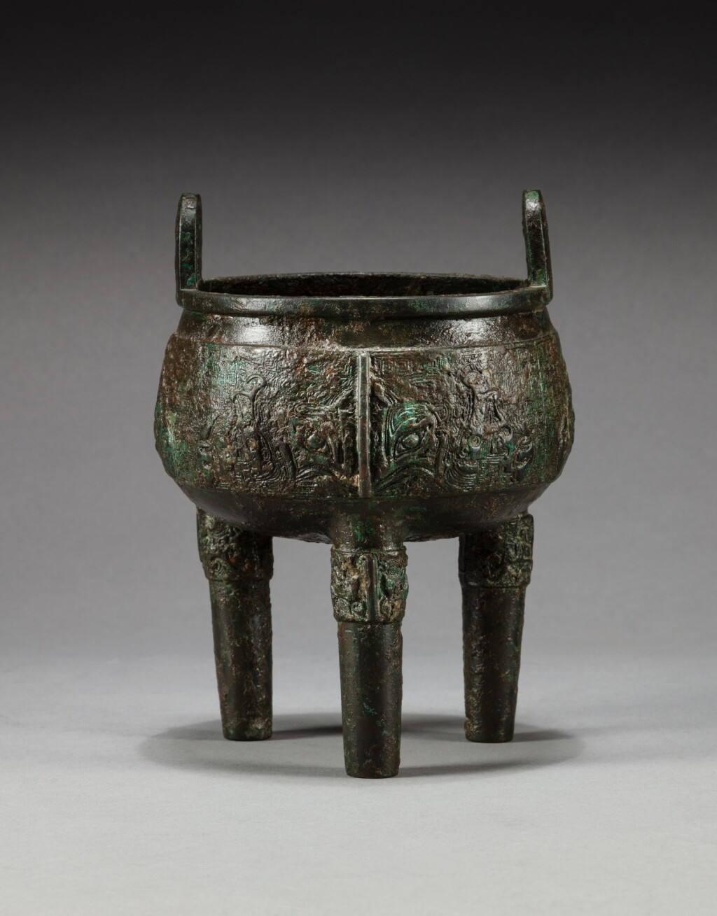View full screen - View 1 of Lot 105. An inscribed archaic bronze tripod incense burner, ding Yuan dynasty | 元 青銅饕餮紋鼎.