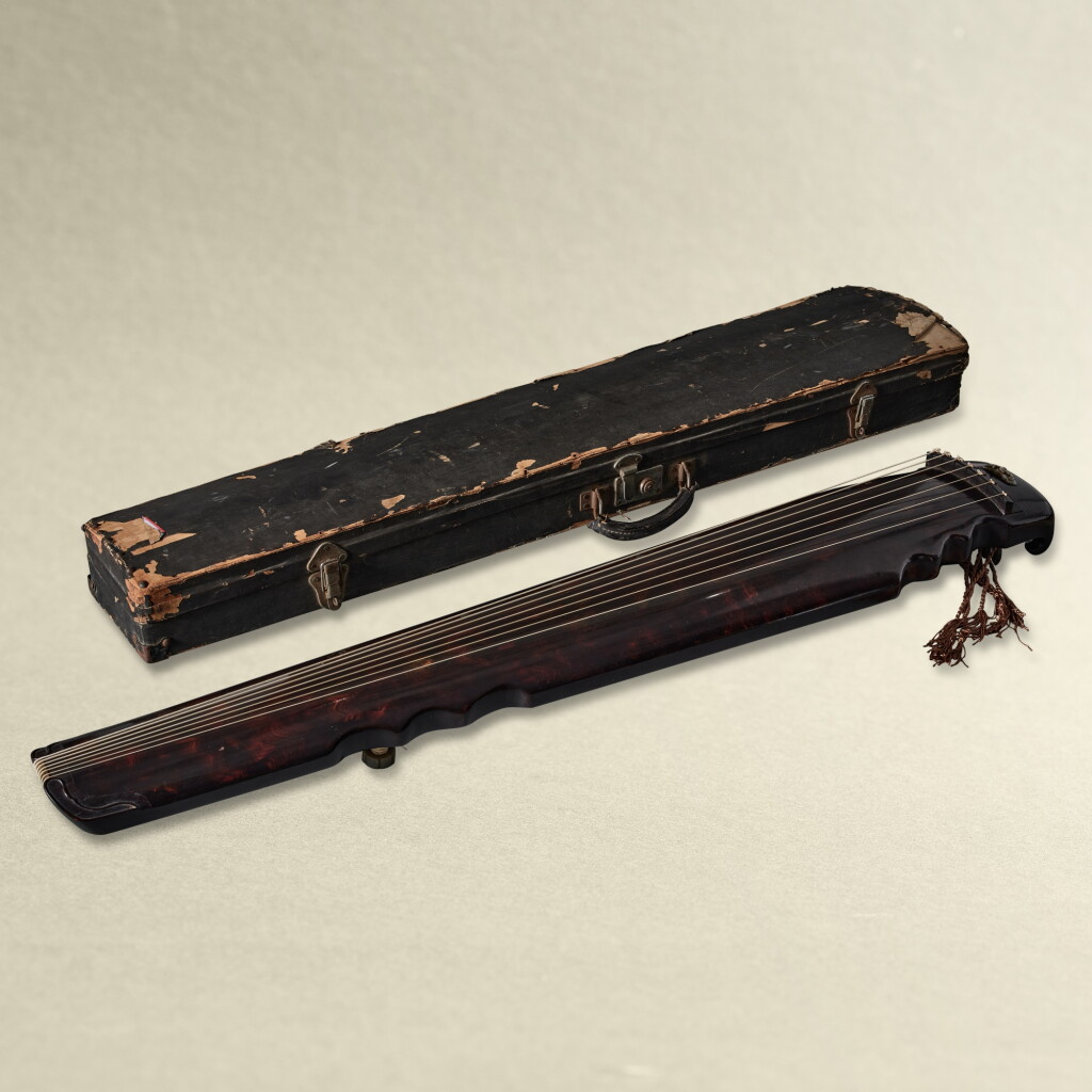 View full screen - View 1 of Lot 5729. A purple-lacquered and cinnabar lacquer-painted lianzhu-style guqin, Ming dynasty | 明 紫漆朱繪卷雲紋連珠式琴.