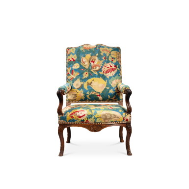 View full screen - View 1 of Lot 130. A Regence wood armchair, circa 1720 | Fauteuil en bois naturel d’époque Régence, vers 1720.