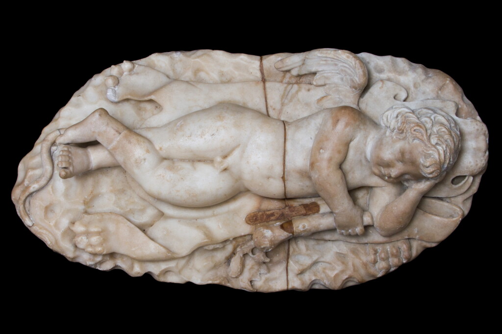View full screen - View 1 of Lot 12. A Roman Marble Figure of Sleeping Eros with the attributes of Herakles, circa 2nd Century A.D., with circa 17th Century Restorations.