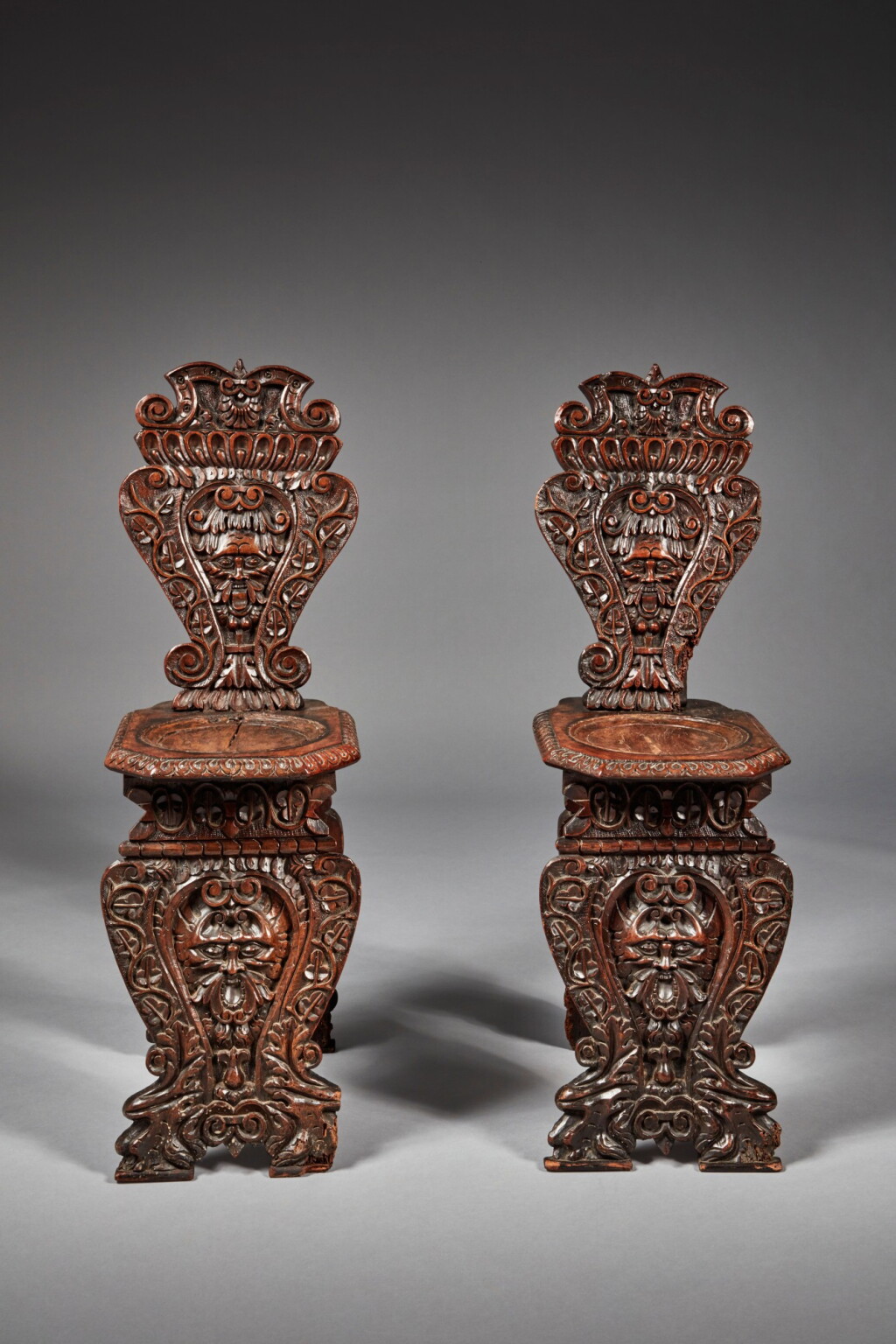 View full screen - View 1 of Lot 152. Pair of Italian late Renaissance carved walnut sgabelli, Late 16th/Early 17th Century and Later.