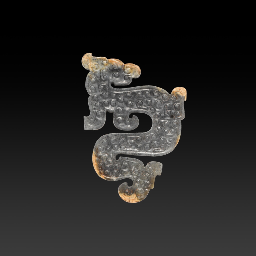 View full screen - View 1 of Lot 109. An archaic celadon and grey jade dragon-form pendant, Eastern Zhou dynasty, late Spring and Autumn period.