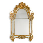 A Régence carved giltwood wall mirror, circa 1720