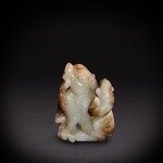 A pale celadon and russet jade 'lions' group, Ming dynasty | 明 青白玉太獅少獅擺件