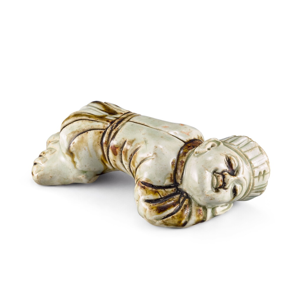 View full screen - View 1 of Lot 411. A RARE BROWN-PAINTED QINGBAI CROUCHING FIGURE YUAN DYNASTY | 元 青白釉褐彩臥人.