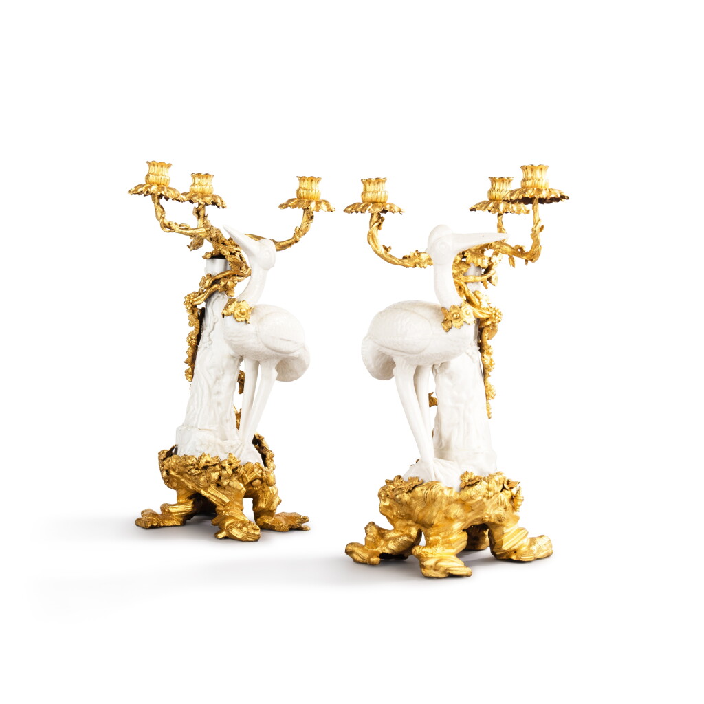 View full screen - View 1 of Lot 38. A pair of gilt-bronze mounted Chinese blanc de Chine porcelain three-light à cigognes candelabra, the porcelain, Dehua, late 17th/early 18th century, the mounts Louis XV, circa 1750.