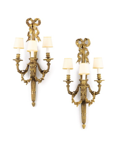 View full screen - View 1 of Lot 185. A pair of French Louis XVI style gilt-bronze three-branch wall-lights,.