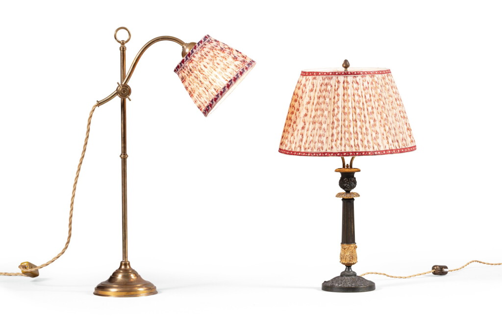 View full screen - View 1 of Lot 110. Lot comprising a French Restauration patinated and gilt bronze candlestick fitted as lamp and a brass lamp | Lot comprenant un flambeau en bronze patiné et doré d'époque Restauration (monté en lampe) et une lampe en laiton.