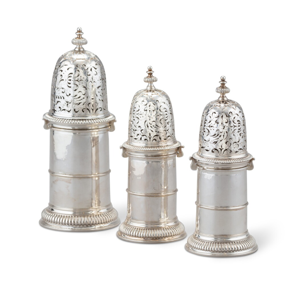 View full screen - View 1 of Lot 120. A set of three William III cylindrical silver casters, John Chadwick, London, 1702 | Ensemble de trois saupoudoirs cylindriques en argent par John Chadwick, Londres, 1702.