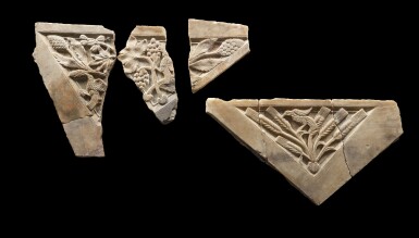 View full screen - View 1 of Lot 24. A Group of Four Large South Arabian Triangular Relief Fragments, circa 1st/2nd Century A.D..