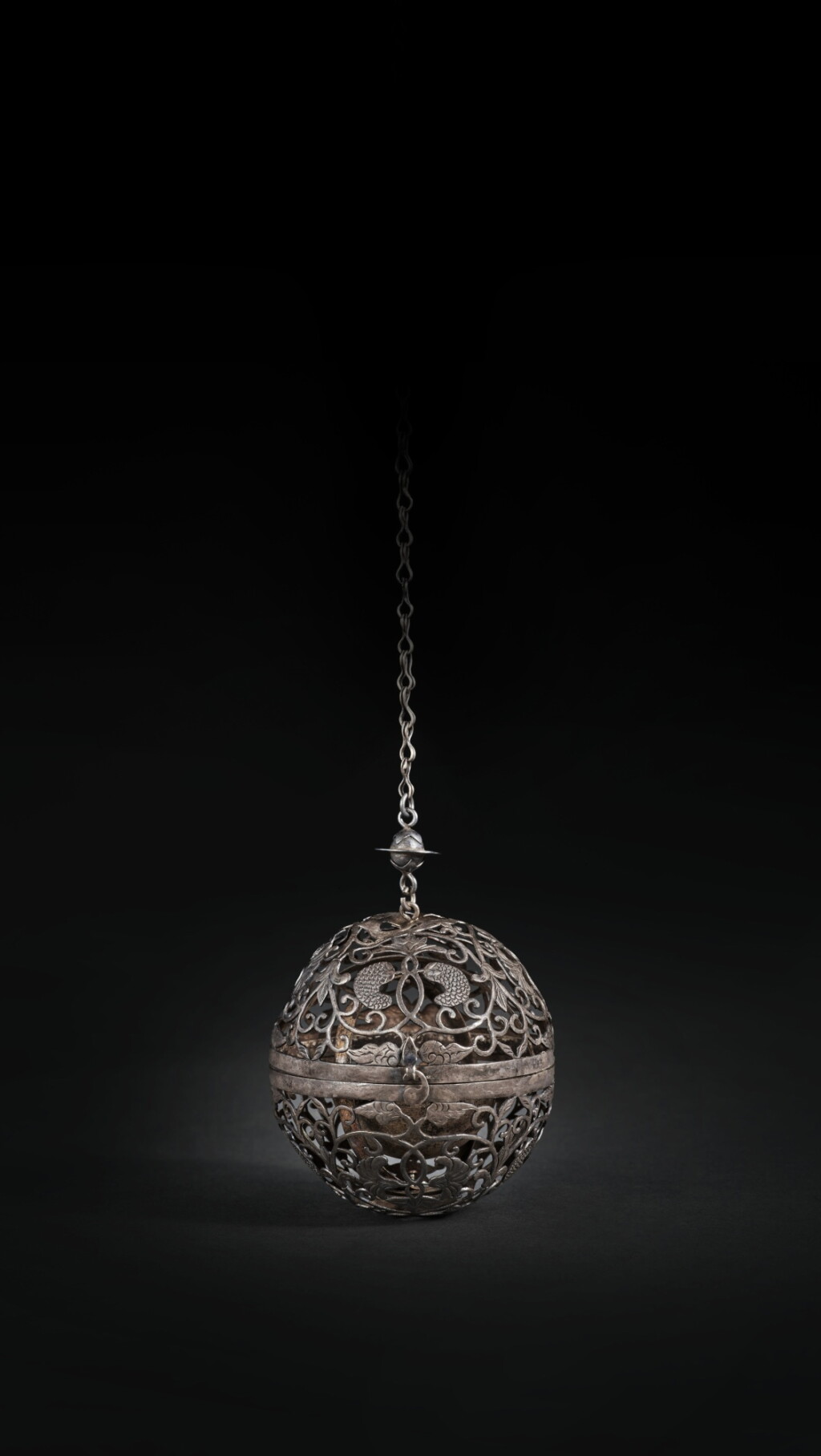 View full screen - View 1 of Lot 214. A rare silver reticulated spherical censer, Tang dynasty | 唐 銀鏤空纏枝葡萄紋香球.