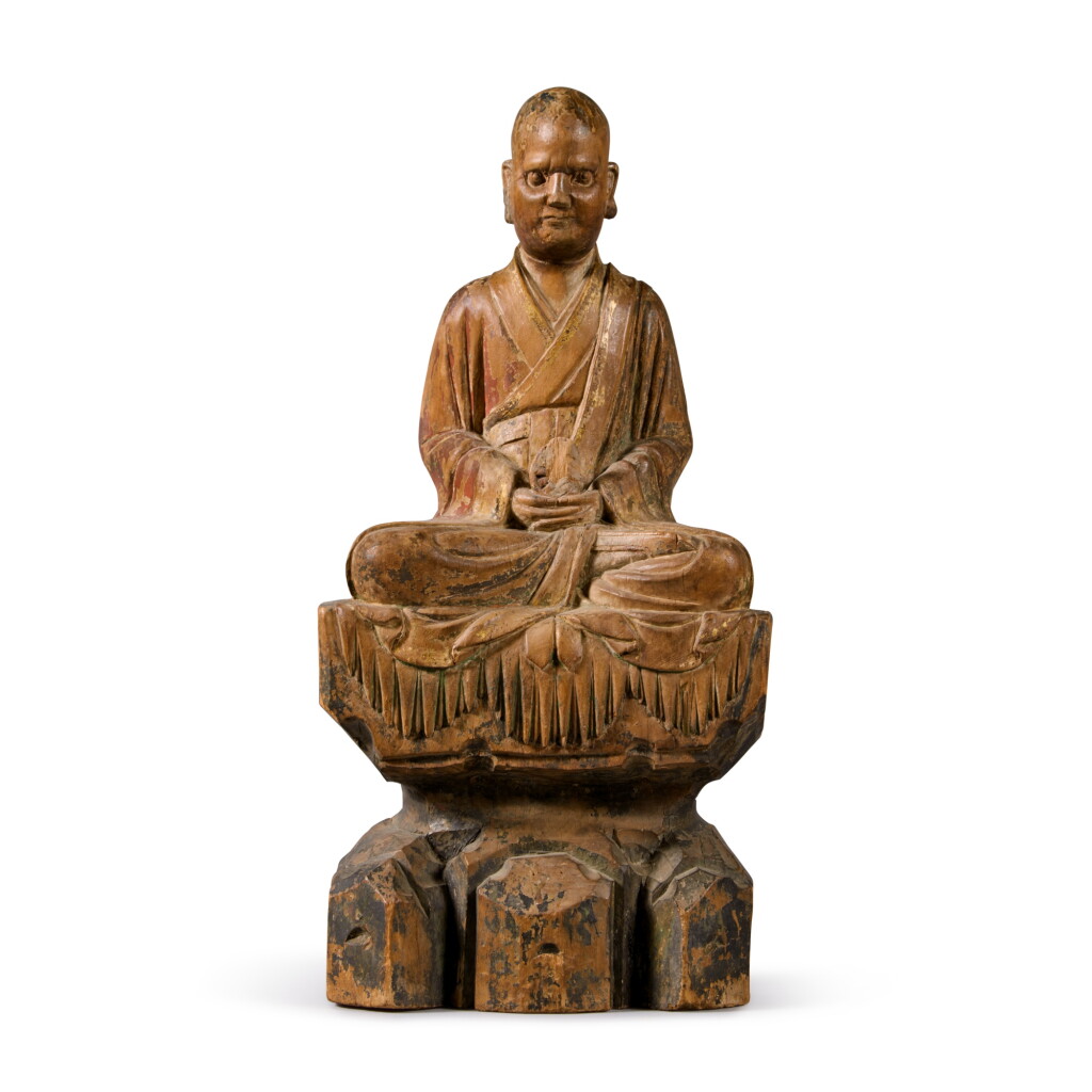 View full screen - View 1 of Lot 819. A polychrome-painted wood figure of a Luohan, Ming dynasty | 明 木雕加彩羅漢坐像.