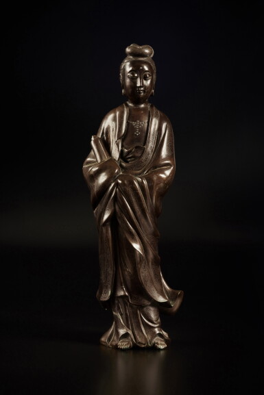 View full screen - View 1 of Lot 684. A silver-inlaid bronze figure of Guanyin, Qing dynasty | 清 銅錯銀觀音立像.