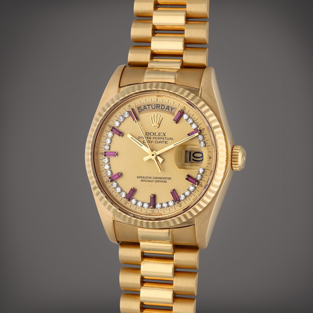View full screen - View 1 of Lot 202. Reference 18038 Day-Date | A yellow gold and diamond and ruby-set automatic wristwatch with day, date, and bracelet, Circa 1981.