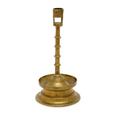 View full screen - View 1 of Lot 58. A Rare Northwestern European Cast Brass Four-Knop Circular-Based Candlestick, 15th Century.