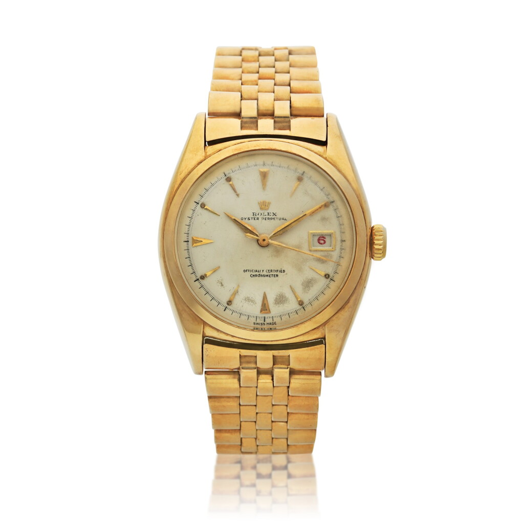View full screen - View 1 of Lot 214. Reference 6030 Oyster Perpetual, A yellow gold wristwatch with date and bracelet, Circa 1961.