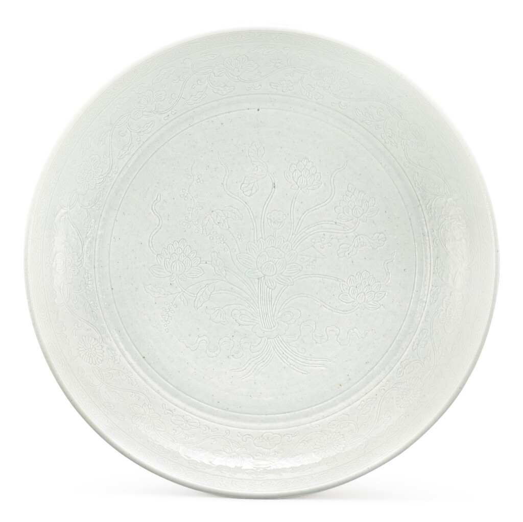 View full screen - View 1 of Lot 117. A RARE INCISED WHITE-GLAZED 'LOTUS BOUQUET' DISH MARK AND PERIOD OF JIAQING | 清嘉慶 白釉暗刻一把蓮盤 《大清嘉慶年製》款.
