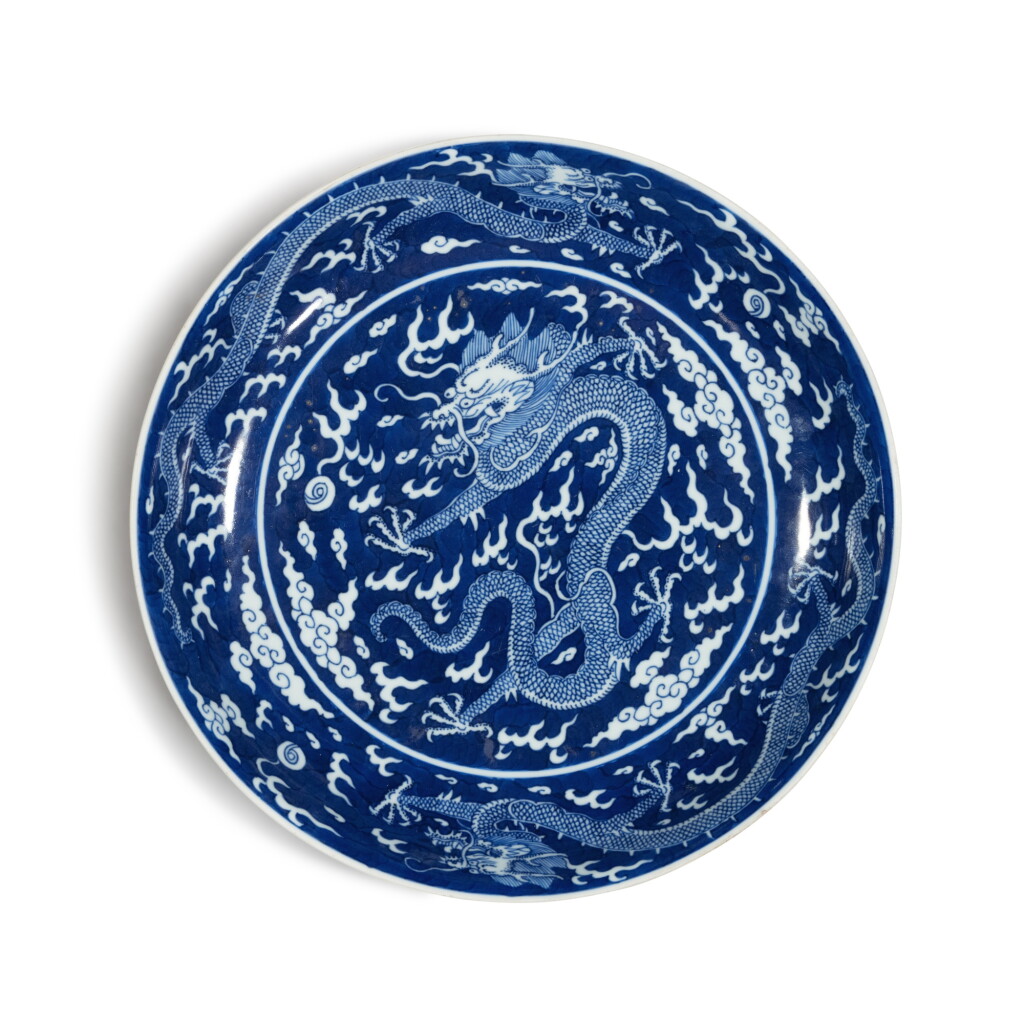 View full screen - View 1 of Lot 708. A reserve-decorated blue and white 'dragon' dish, Seal mark and period of Qianlong | 清乾隆 青花地留白遊龍戲珠紋盤 《大清乾隆年製》款.