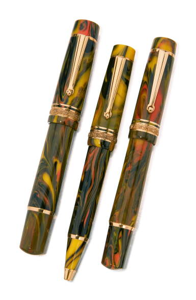 View full screen - View 1 of Lot 1049. DELTA | A SET OF THREE MULTI-COLORED SWIRL RESIN AND GOLD PLATED WRITING INSTRUMENTS, CONSISTING OF ONE FOUNTAIN PEN, ONE BALLPOINT PEN AND ONE ROLLERBALL PEN, CIRCA 2000.