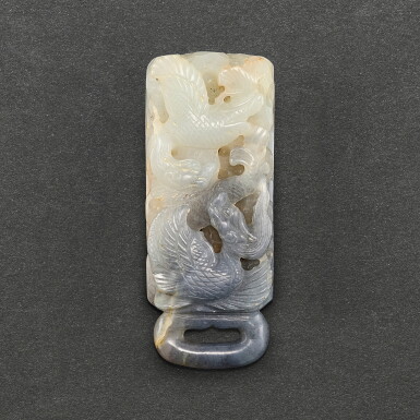 View full screen - View 1 of Lot 550. A BLACK AND WHITE JADE 'WINGED DRAGON' BELT BUCKLE YUAN DYNASTY | 元 墨白玉巧雕龍紋帶扣.
