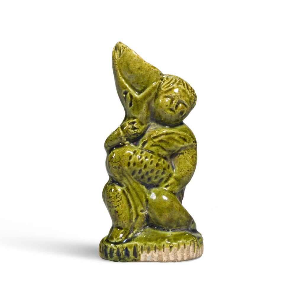 View full screen - View 1 of Lot 220. A RARE MINIATURE GREEN-GLAZED 'FOREIGN BOY' WINE VESSEL, TANG DYNASTY | 唐 綠釉胡人形小酒尊.