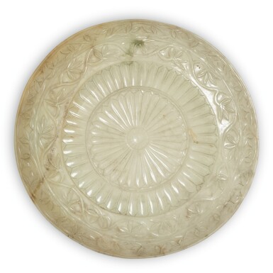 View full screen - View 1 of Lot 45. A Mughal-style celadon jade 'chrysanthemum' dish, Qing dynasty, 19th century | 清十九世紀 青玉雕痕都斯坦式盤.