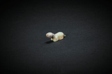 View full screen - View 1 of Lot 3822. A pale celadon jade recumbent animal, Eastern Zhou dynasty, early Warring States period | 東周戰國早期 淺青玉渦紋坐獸形飾.