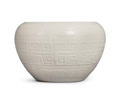 View full screen - View 1 of Lot 326. A molded white-glazed soft-paste jar, Qing dynasty, 18th century | 清十八世紀 白釉仿古迴紋罐.