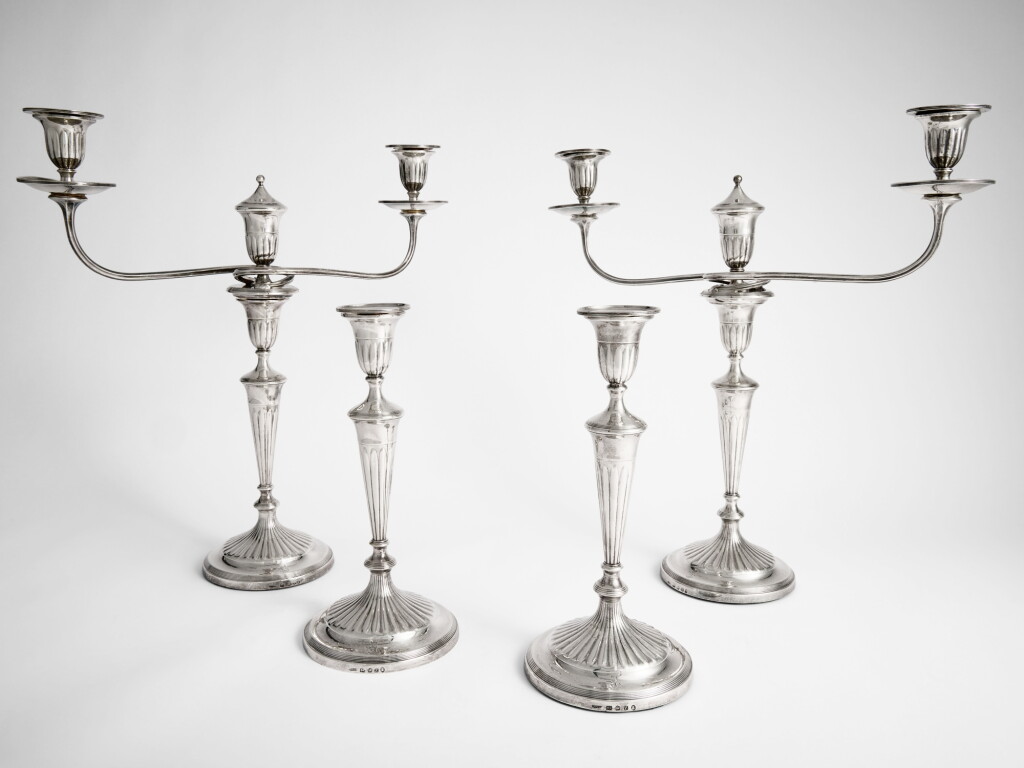 View full screen - View 1 of Lot 668. A Pair of Regency Silver Three-Light Candelabra and a Matching Pair of George IV Silver Candlesticks, John Green & Co., Sheffield, 1817 and 1822.