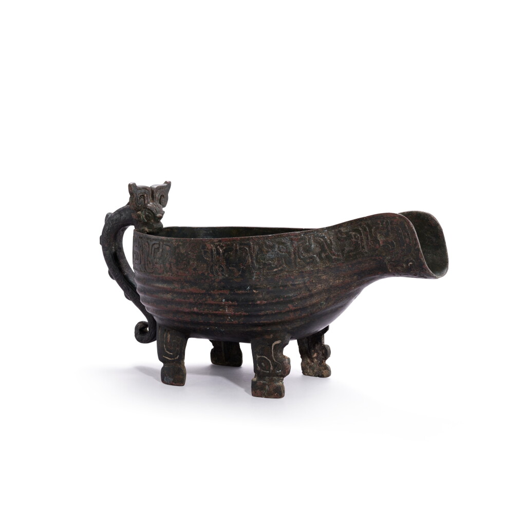 View full screen - View 1 of Lot 719. A bronze dragon-handled ritual pouring vessel, yi, Eastern Zhou dynasty, Spring and Autumn period | 東周春秋 青銅龍鋬夔龍紋四足匜.