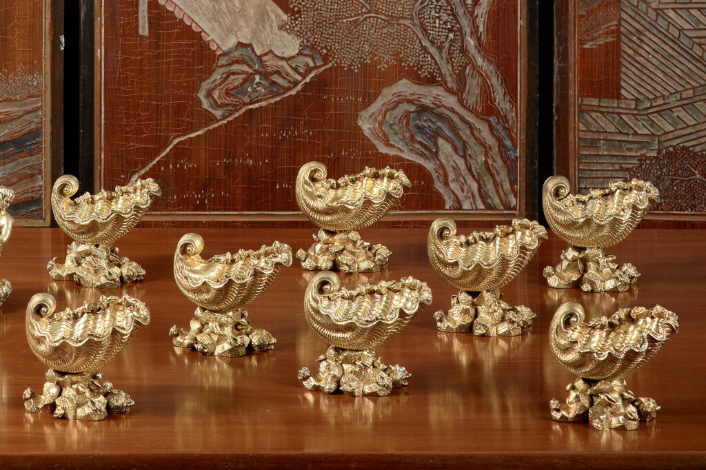 View full screen - View 1 of Lot 108. A Set of Eight George IV Silver-Gilt Shell Salts, Edward Farrell, probably retailed by Kensington Lewis, London, 1822.