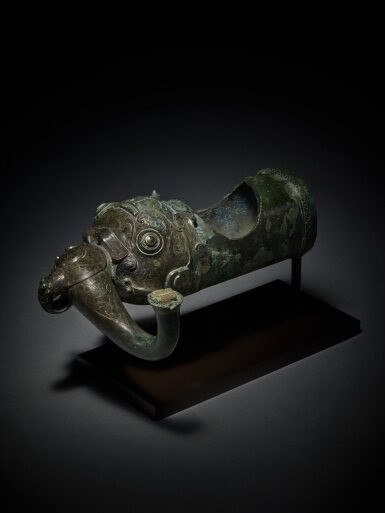 View full screen - View 1 of Lot 20. An exceptionally rare silver and gold-inlaid zoomorphic fitting Eastern, Zhou dynasty, Warring States period | 東周 戰國 銅錯金銀獸面紋部件.