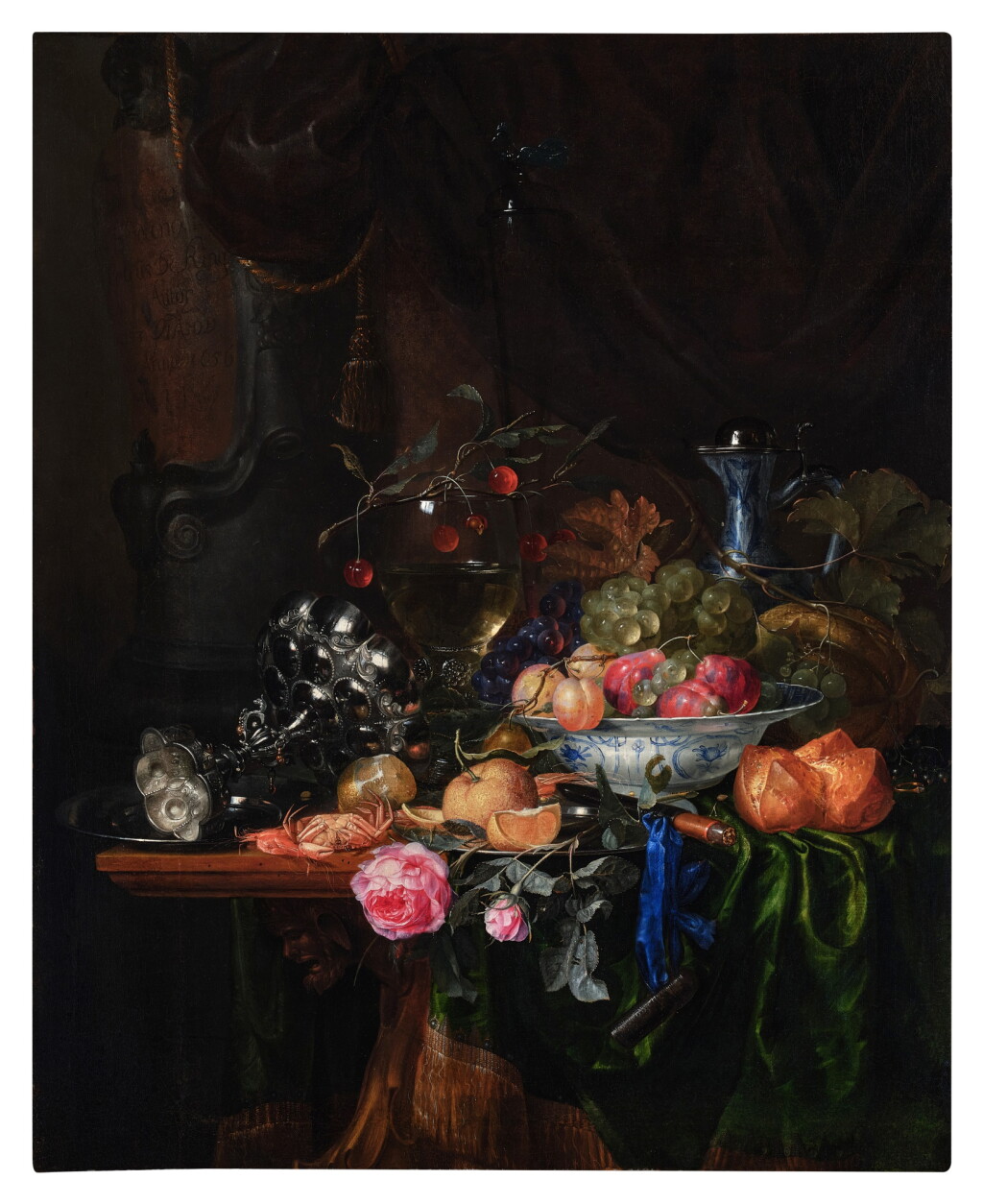 View full screen - View 1 of Lot 113. Still life with a tazza, pears, plums, a Wan-Li bowl, a roll, grapes, lemons, cherries, and a glass of wine, all on a table draped in a green cloth and set before a curtain.