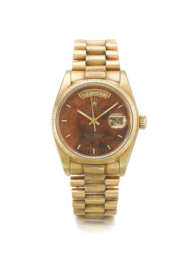 View full screen - View 1 of Lot 118. ROLEX | REF 18078/18000 DAY-DATE | A YELLOW GOLD AUTOMATIC WRISTWATCH WITH DAY, DATE, BRACELET, AND WOOD DIAL CIRCA 1984 .