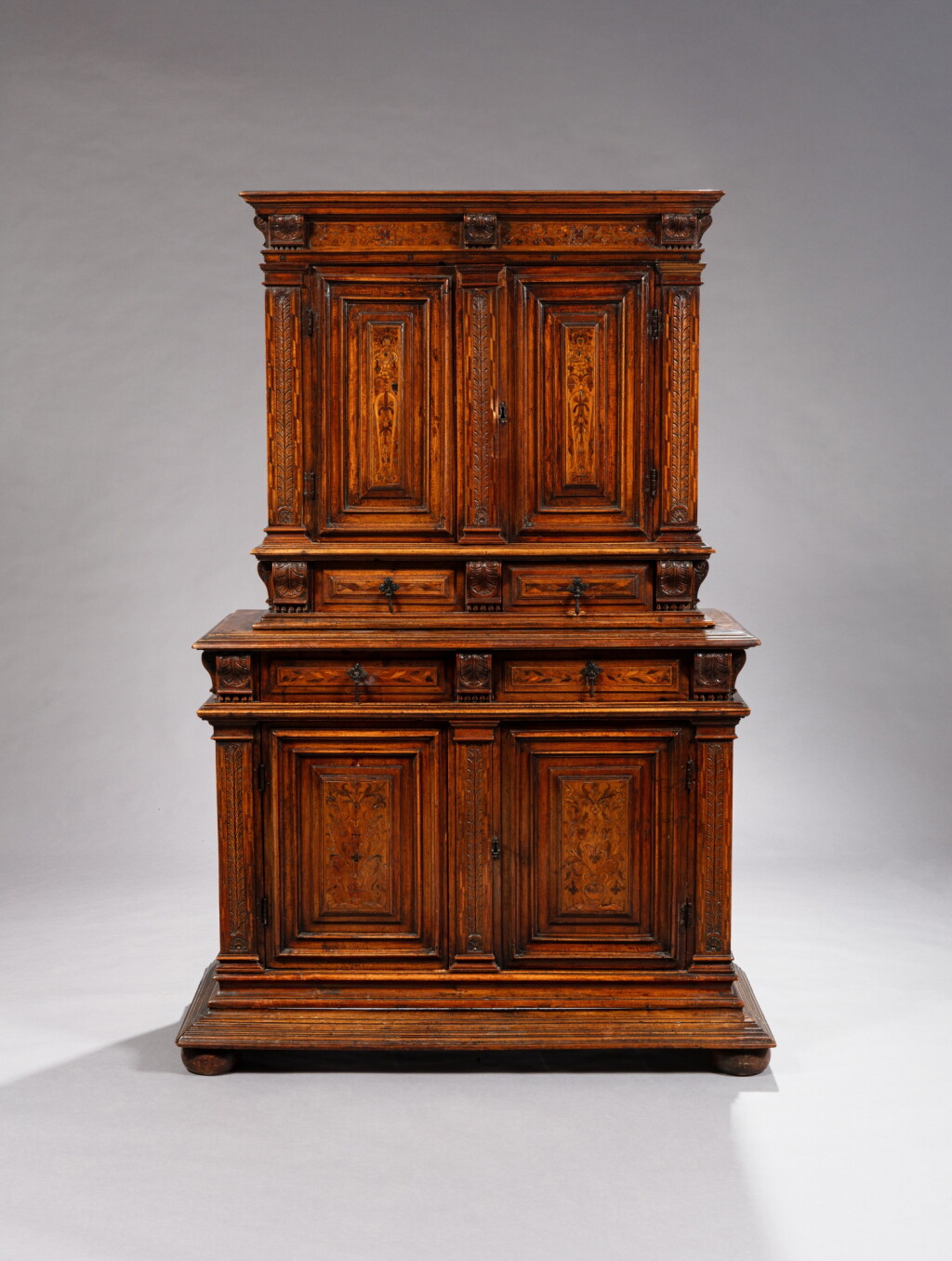 View full screen - View 1 of Lot 524. A French moulded and carved walnut two-part cabinet, late 16th century.