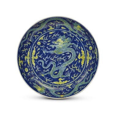 View full screen - View 1 of Lot 401. An underglaze-blue and yellow-enameled 'dragon' dish, Seal mark and period of Qianlong | 清乾隆 青花地黃彩雲龍趕珠紋盤 《大清乾隆年製》款.
